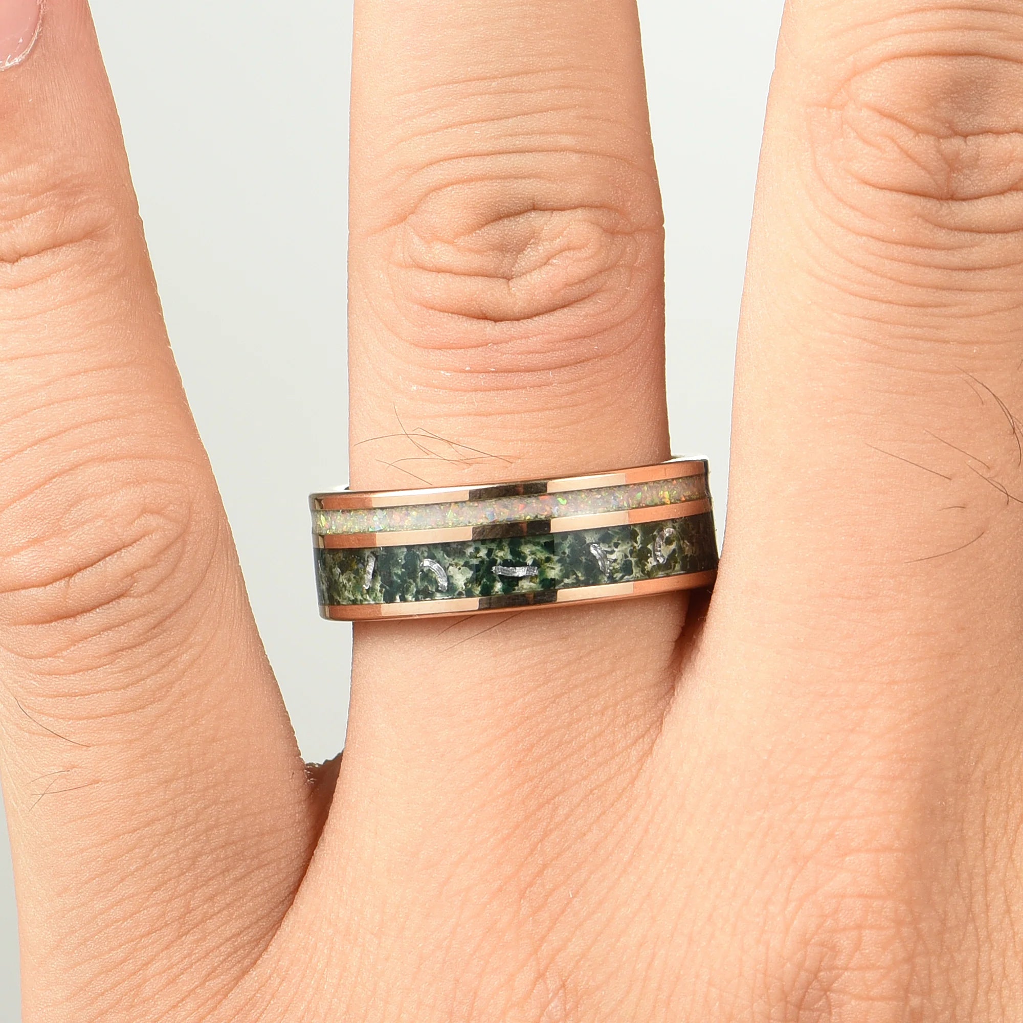 His her rings shown on male hand featuring meteorite ring for him