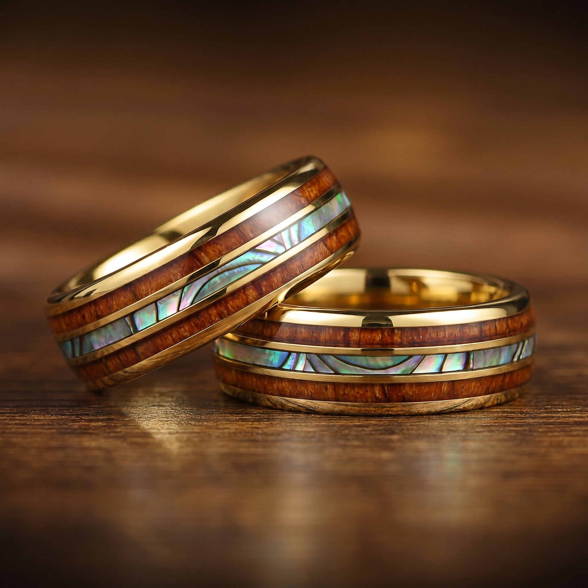 Male engagement bands featuring natural koa wood and polished gold finish