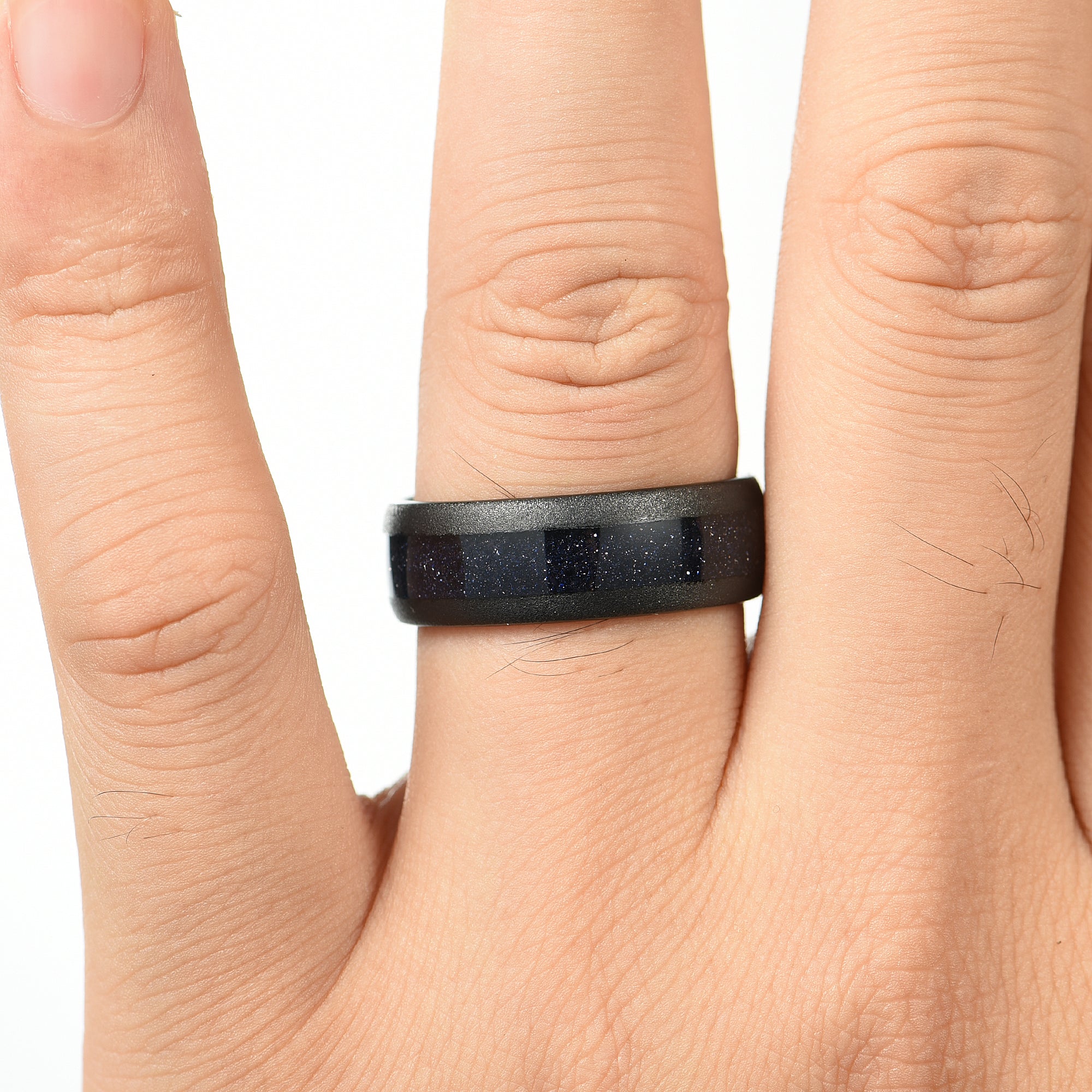 Mens promise rings black tungsten band with nebula inspired centre inlay on Male Hand