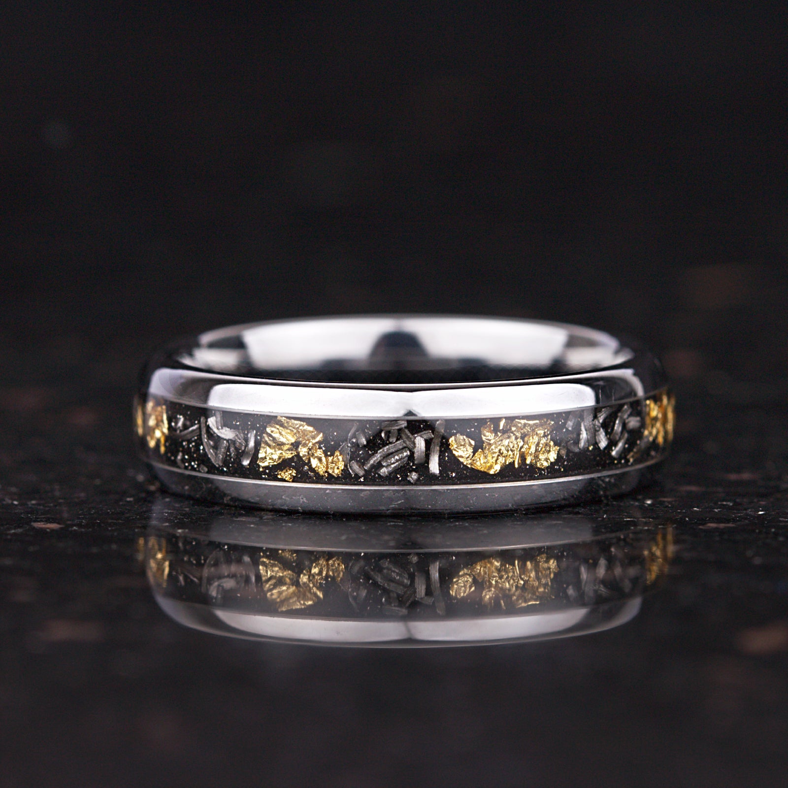 Metal rings with meteorite and gold leaf detail on silver finish
