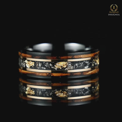 A video of a Mens Black Wedding Band with Meteorite and Smoked Wood rotating on a reflective black glass surface, highlighting its design.