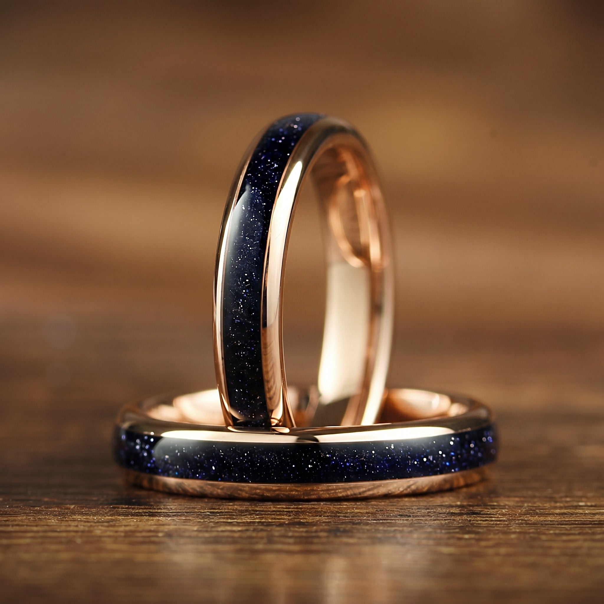 Rose gold commitment rings with blue sandstone detail in polished tungsten band for her