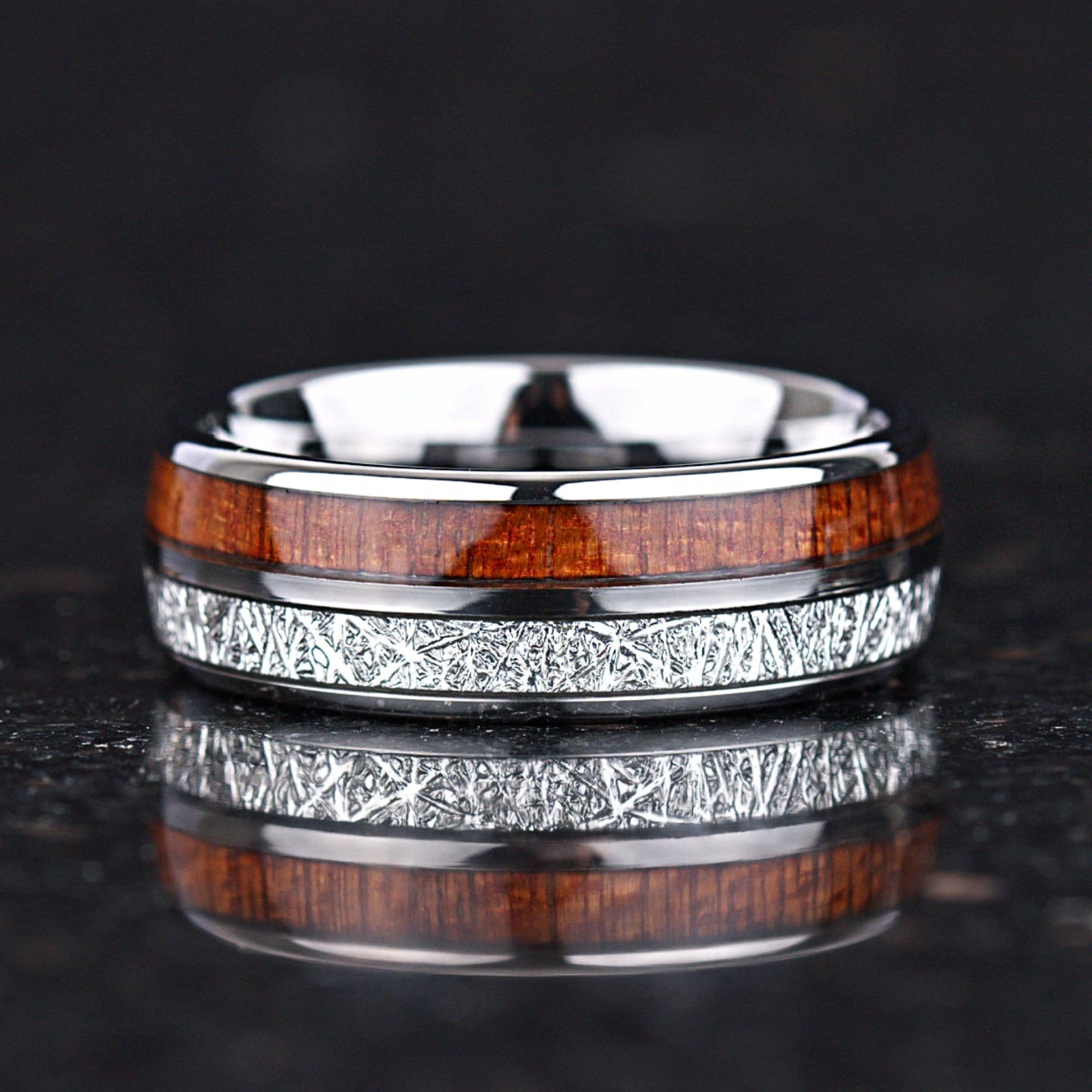 Silver promise rings set with meteorite style detail and polished finish