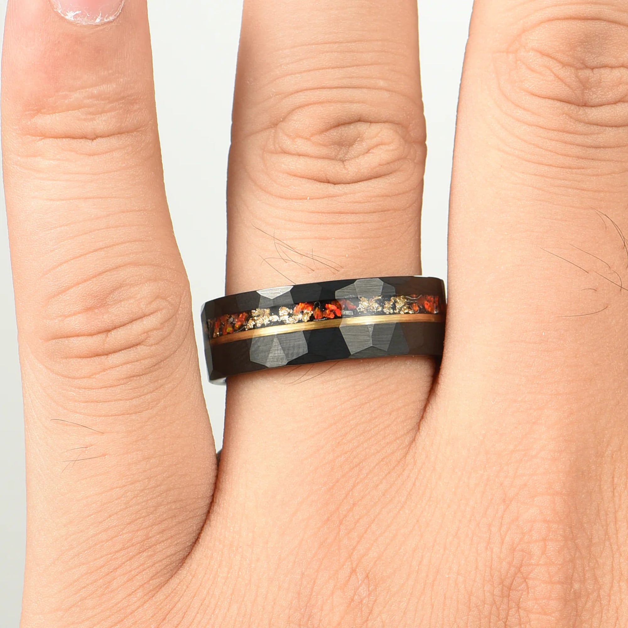Tungsten ring set with fire opal and gold leaf detail male hand view