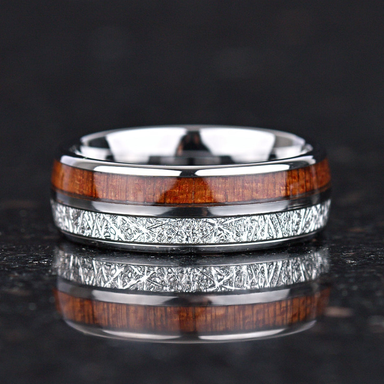 Two tone wedding bands silver and wood design close up